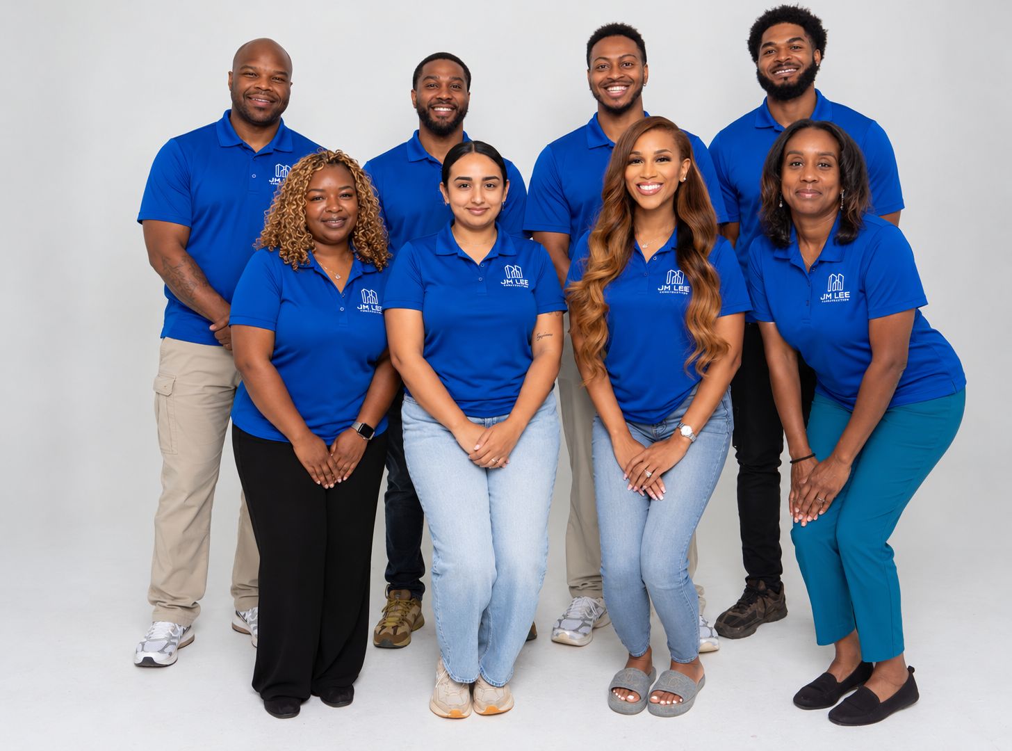 All eight members of the J.M. Lee Construction team, shown in a waist-up group crop